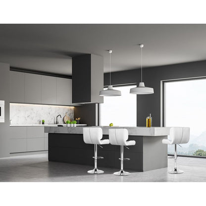 Modern kitchen with grey cabinets, white countertops, and white bar stools.