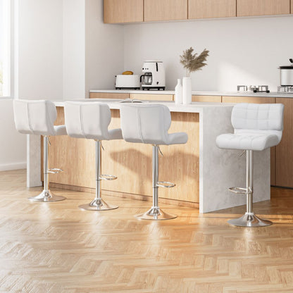 White bar stools in a modern kitchen setting with wooden cabinets and a coffee machine.