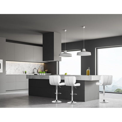 Modern kitchen with gray cabinets, white countertops, and white bar stools.