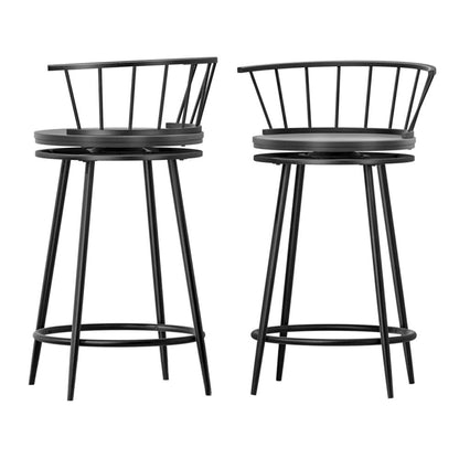 Two black metal bar stools with round seats on a white background