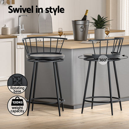 Two black bar stools with a rotating base and 120KG weight capacity in a kitchen setting.