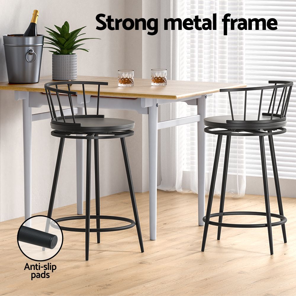 Two black bar stools at dining table showing strong metal frame and anti-slip pads